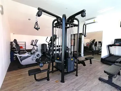 a gym with treadmills and exercise equipment at Palmyrah Surin Beach By Risa in Surin Beach