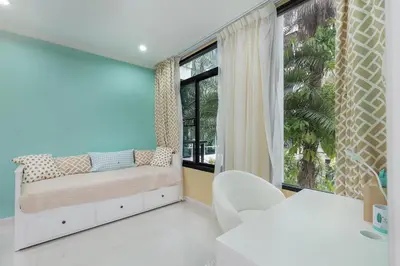 a bedroom with a bed and a large window at The Kamala Regent by My Home Phuket in Kamala Beach