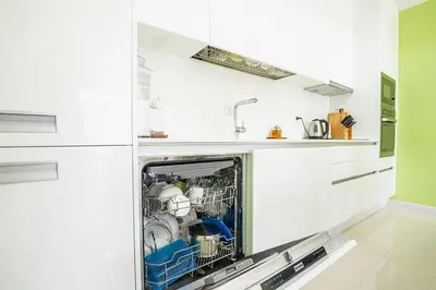 a dishwasher with dishes in it in a kitchen at The Kamala Regent by My Home Phuket in Kamala Beach