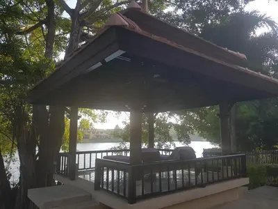 a gazebo with a person sitting in it at laguna waters \u60a6\u6995\u5e84 \u62c9\u53e4\u7eb3 in Bang Tao Beach