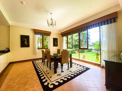 a dining room with a table and chairs and a large window at laguna waters \u60a6\u6995\u5e84 \u62c9\u53e4\u7eb3 in Bang Tao Beach