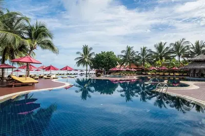 a pool at the resort with palm trees and umbrellas at laguna waters \u60a6\u6995\u5e84 \u62c9\u53e4\u7eb3 in Bang Tao Beach