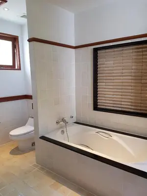 a bathroom with a bath tub and a toilet at laguna waters \u60a6\u6995\u5e84 \u62c9\u53e4\u7eb3 in Bang Tao Beach