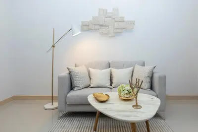 a living room with a couch and a table at Palmetto by Holy Cow, 2-BR, jungle view in Karon Beach