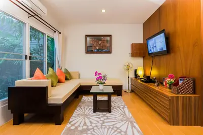 a living room with a couch and a tv at Irawan House in Ao Nang Beach