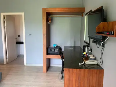 a room with a desk and a television in a room at Aonang Inn in Krabi town