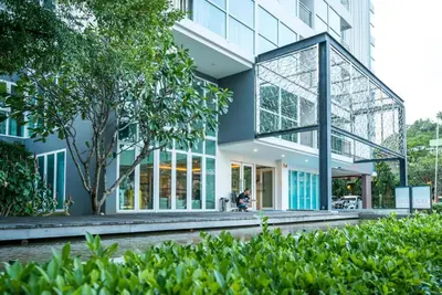 an office building with a glass facade at Ozone Kata -Great location, rooftop pool, convenient studio in Karon Beach