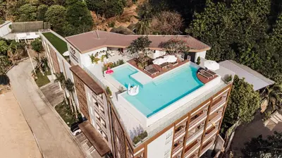 an overhead view of a house with a swimming pool at Palmetto Condominium in Karon Beach