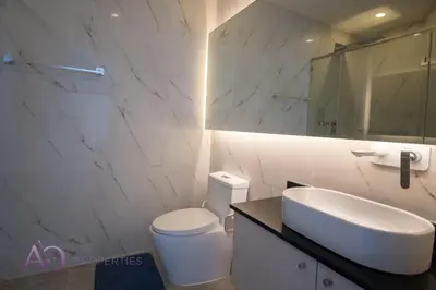 a white bathroom with a sink and a toilet at Luxury Lagoon 1bedroom Apartment in Kamala Beach