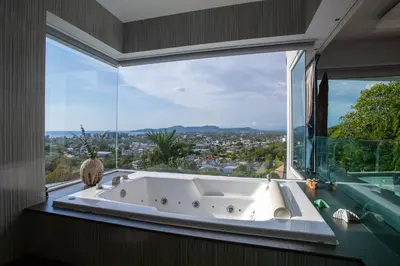 a bath tub in a room with a large window at Villa Beyond-Namaste 16 Bedroom Fully Staffed Seaview Villa in Ban Thalat Choeng Thale