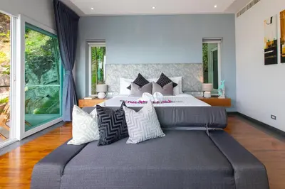 a bedroom with a large bed with pillows at Villa Beyond-Namaste 16 Bedroom Fully Staffed Seaview Villa in Ban Thalat Choeng Thale