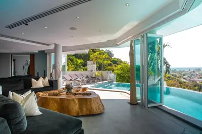a living room with a table and a pool at Villa Beyond-Namaste 16 Bedroom Fully Staffed Seaview Villa in Ban Thalat Choeng Thale