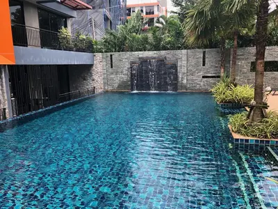 a swimming pool with a door in a building at Relife Windy by Nataly in Phuket Town