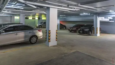 a parking garage with several cars parked in it at Relife Windy by Nataly in Phuket Town
