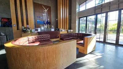 a lobby with two chairs and a couch in a building at Relife Windy by Nataly in Phuket Town