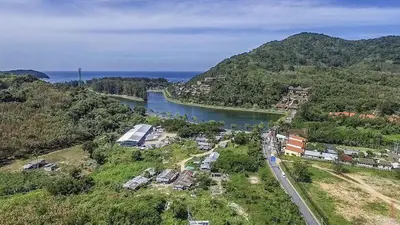an aerial view of a river and a town next to a mountain at Relife Windy by Nataly in Phuket Town