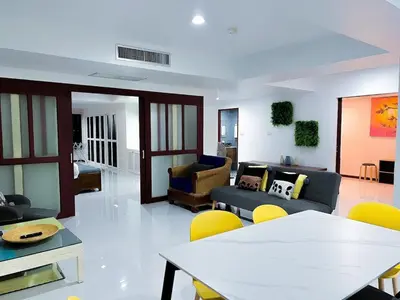 a living room with a couch and a table and chairs at The Sands 3 Bedrooms Beachside Apartment in Naiharn in Nai Harn Beach