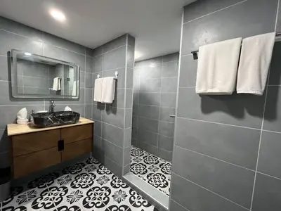 a bathroom with a sink and a mirror at The Sands 3 Bedrooms Beachside Apartment in Naiharn in Nai Harn Beach