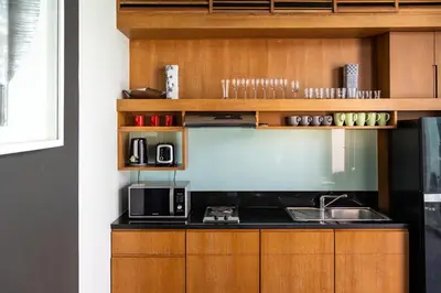a kitchen with a sink and a microwave at Beautiful 3 bedroom pool villa with 65inch smart tv Located near popular Bangtao beach and laguna Phuket in Bang Tao Beach