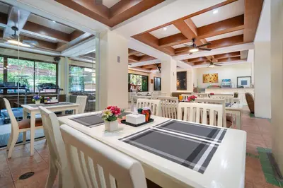 a dining room with a table and chairs at Patong Central Residence and Apartment in Patong Beach
