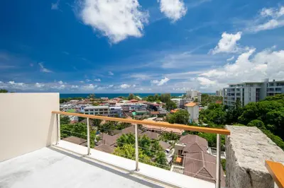 a balcony with a view of a city at Prima Villas Karon Phuket in Karon Beach