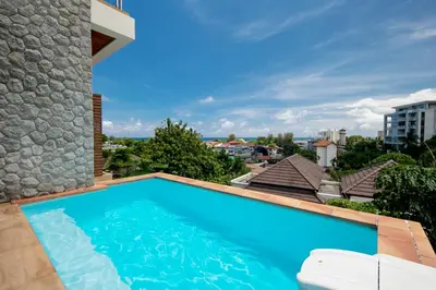 a swimming pool on the roof of a building at Prima Villas Karon Phuket in Karon Beach
