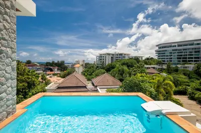 a swimming pool on top of a building at Prima Villas Karon Phuket in Karon Beach