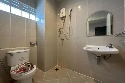 a bathroom with a toilet and a sink at SB Park Mansion in Phuket Town