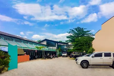 a white truck parked in front of a building at Baan Kim Lian SHA in Phuket Town