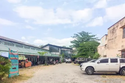 a white truck parked in front of a building at Baan Kim Lian SHA in Phuket Town