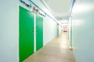 a row of green lockers in a hallway at Baan Kim Lian SHA in Phuket Town