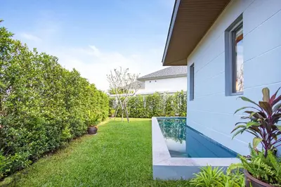 a garden with a swimming pool next to a house at Modern Pool Villa Dalaa 7 in Kamala Beach