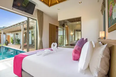 a bedroom with a large bed and a swimming pool at Modern Pool Villa Dalaa 7 in Kamala Beach