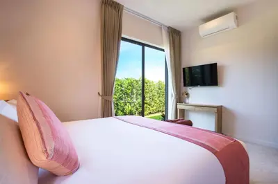 a bedroom with a bed and a large window at Modern Pool Villa Dalaa 7 in Kamala Beach
