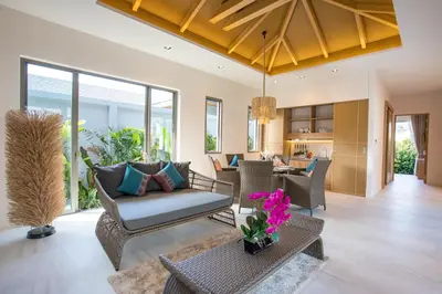 a living room with a couch and a table at Modern Pool Villa Dalaa 7 in Kamala Beach