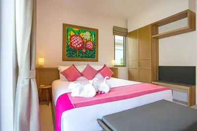 a bedroom with a bed with two swans on it at Beach escape at Villa Dalaa 8 in Kamala Beach