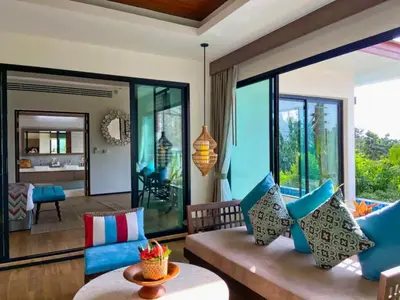 a living room with a couch and a large window at Silla Villa Private Pool & Sea View in Kata Beach