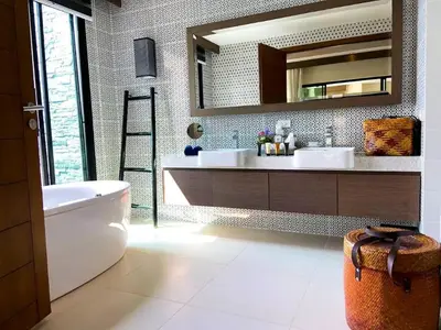 a bathroom with a tub and a sink and a mirror at Silla Villa Private Pool & Sea View in Kata Beach