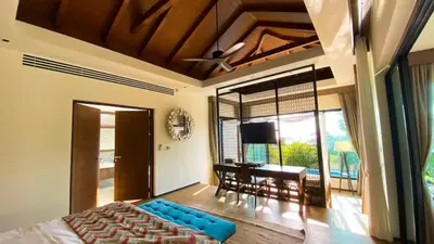 a bedroom with a bed and a dining room with a table at Silla Villa Private Pool & Sea View in Kata Beach