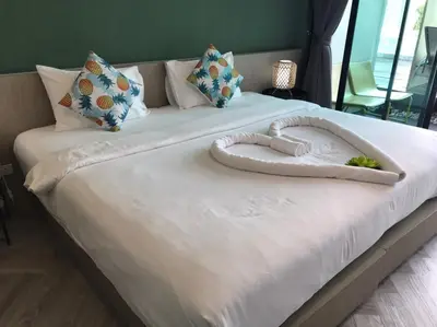 a large white bed with a heart on it at Yanud Residence in Phuket Town