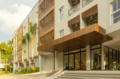 an exterior view of a building with large windows at Palmetto by Holy Cow, 2-BR, Sea View in Karon Beach