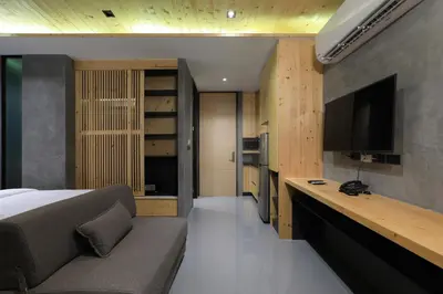 a bedroom with a bed and a flat screen tv at Relife Windy by Holy Cow, studio with sofa-bed in Rawai Beach