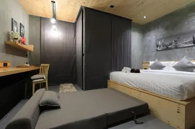 a bedroom with a bed and a desk and a chair at Relife Windy by Holy Cow, studio with sofa-bed in Rawai Beach