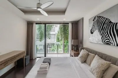 a bedroom with a bed and a zebra picture on the wall at 5bdr Pool Villa In Laguna Park #46 By Capital Pro in Bang Tao Beach