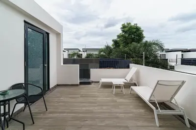 a patio with chairs and a table on a balcony at 5bdr Pool Villa In Laguna Park #46 By Capital Pro in Bang Tao Beach