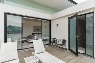 a living room with white chairs and a table at 5bdr Pool Villa In Laguna Park #46 By Capital Pro in Bang Tao Beach