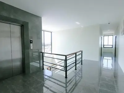 a hallway with a metal railing in a building at Nai Yang Residence in Nai Yang Beach