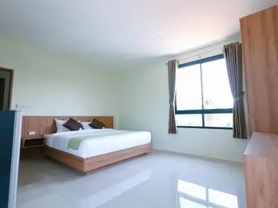 a bedroom with a bed and a large window at Nai Yang Residence in Nai Yang Beach