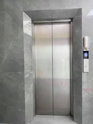 a elevator in a building with a silver door at Nai Yang Residence in Nai Yang Beach