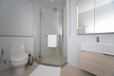 a bathroom with a toilet and a glass shower at 1bdr Pool Access Apartment Bangtao #5103 in Bang Tao Beach